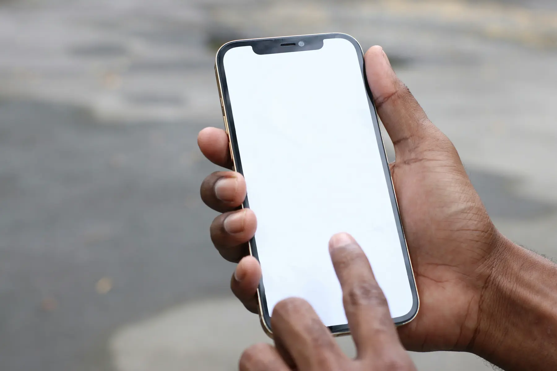 Hands holding a phone with a blank screen, representing the mobile buy area of a product page